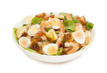 Shrimp salad with lettuce, arugula, quail eggs, cherry tomatoes, olive oil and balsamic vinegar. Caesar salad with shrimp. Isolated background.