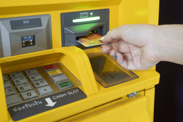 Woman hand used ATM card or credit card for withdraw money from ATM machine.