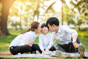 Asian family portrait with happy people smiling at the park ,Lifestyle and Holiday Concept.