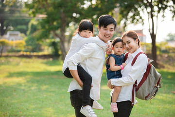 Fototapeta premium Asian family portrait with happy people smiling at the park ,Lifestyle and Holiday Concept.