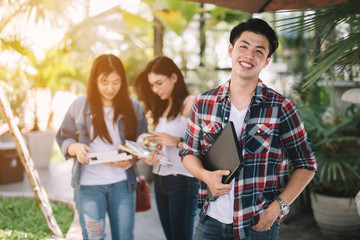 Group of cheerful young students in university