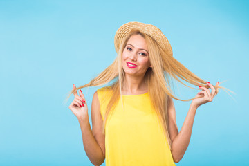 Portrait of happy cheerful smiling young beautiful blond woman on blue background