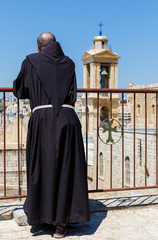 Fototapeta premium Priest viewing the Church of Nativity in Bethlehem, Palestine