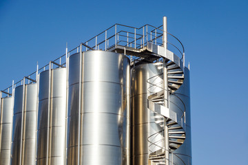 Silver wine Silos with blue sky in background