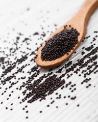 fresh amaranth grains on a rustic background