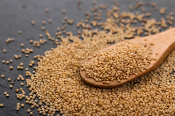 fresh amaranth grains on a rustic background