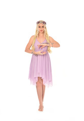 full length portrait of pretty blonde girl wearing purple fairy dress. standing pose, isolated on white studio background.