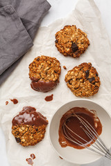 Vegan oatmeal cookies with chocolate on a light background, top view. Food blog style concept.