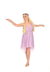 full length portrait of pretty blonde girl wearing purple fairy dress. standing pose, isolated on white studio background.