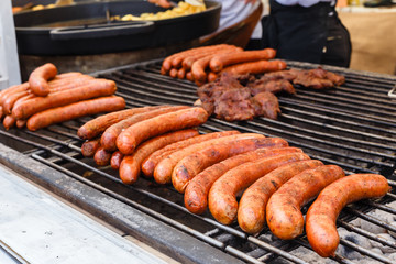 Street food, fast food, Cook fry delicious grilled sausages