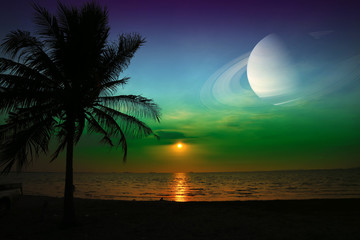 Saturn near earth on night sky over the sea and sunset
