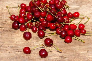 Fresh ripe cherries on rustic wooden table. Top view