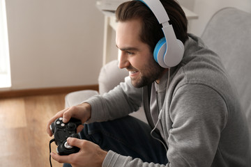 Young man playing video games at home