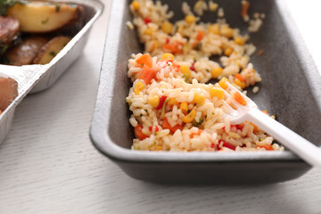 Container with rice on table. Food delivery