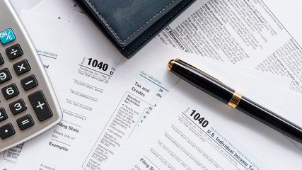 United state 1040 induvidual tax return form with pen