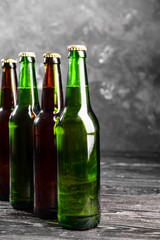 Fresh beer in glass bottles on table