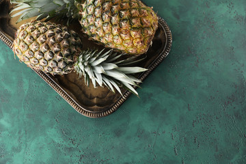 Tasty pineapples on textured table