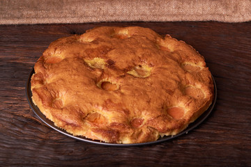 apricot cake on a dark wood background. tinting. selective focus