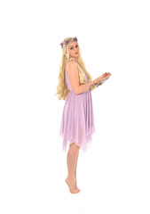 Naklejka premium full length portrait of pretty blonde girl wearing purple fairy dress. standing pose, isolated on white studio background.