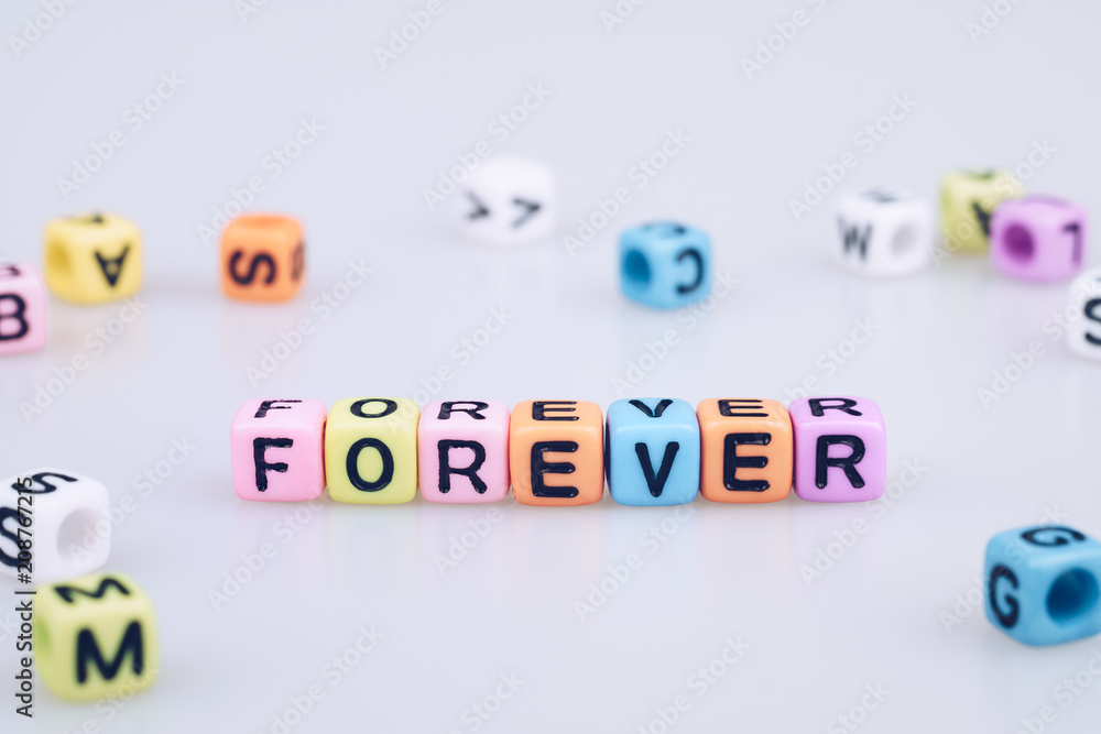 Poster forever word text written on colorful cube with bokeh cube word block background