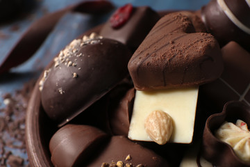 Plate with tasty chocolate candies, closeup
