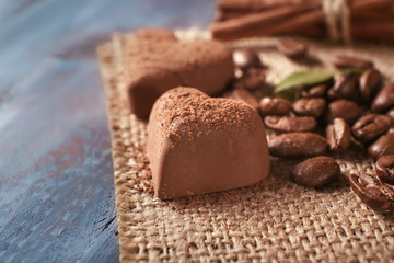 Tasty chocolate candies on wooden table, closeup