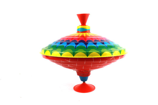 A Vintage 1970s Children's Spinning Top in Rainbow Colours on White 