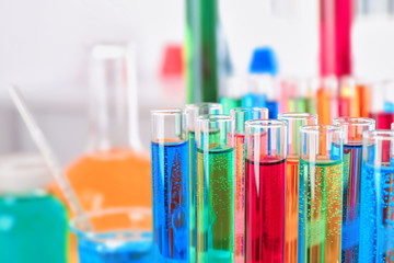 Many test tubes with colorful liquids, closeup