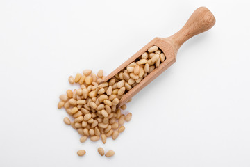 peeled pine nuts on a white acrylic background