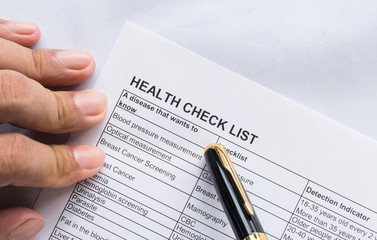 Person health check list paper with hand
