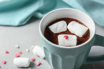 Cup of yummy hot chocolate with marshmallow on table