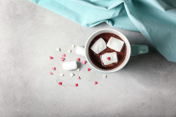Cup of yummy hot chocolate with marshmallow on table