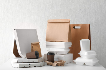 Assortment of food delivery containers on white table