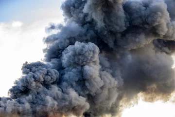 Zelfklevend Fotobehang Huge black smoke cloud from fire © leszekglasner