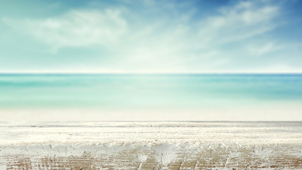 Tropical Beach Background with Sand, Blue Sky and Sea – Wooden table or deck and Copy Space for...