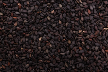 fresh sesame seeds on a rustic background