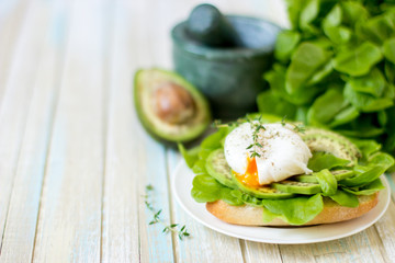 Egg-poached with ciabatta, avocado and baby lettuce leaves