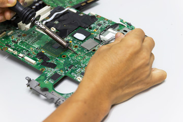 technician repairing electronic of the computer's circuit board by soldering Irons, concept  technology of computer circuit hardware