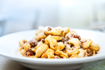 Pasta with pesto sauce and nuts on a the table