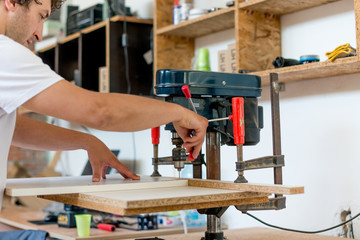 Carpenter drilling holes