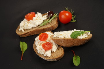 White cheese and cherry tomatoes on a slices of bread