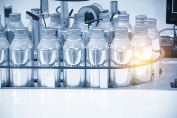 The aluminum bottle container in the conveyor belt in the modern factory.Hi-technology food factory.