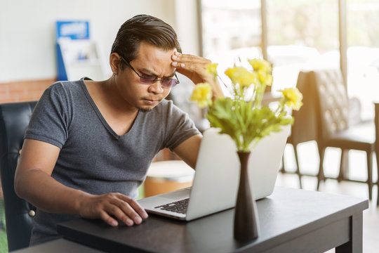 man under a lot of stress using laptop computer