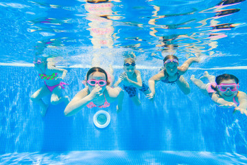 Children swim in  pool - obrazy, fototapety, plakaty