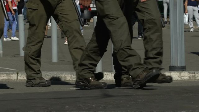 Men in military uniform cordon off building, threat of terrorist act, slow-mo
