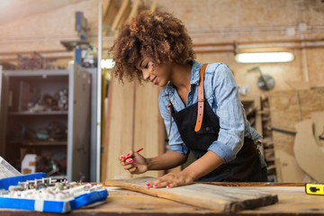 Afro american woman craftswoman working in her workshop

