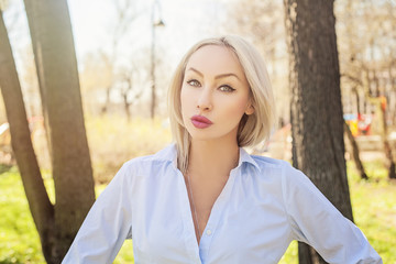 Beautiful woman in blue blouse outdoors portrait