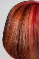 Short fashionable haircut with creative colored red hair