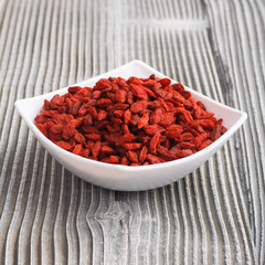 dried goji berries on a wooden rustic background