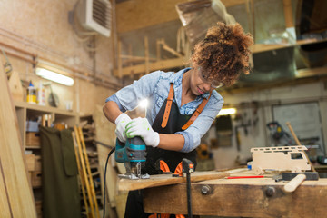 Afro american woman craftswoman working in her workshop

